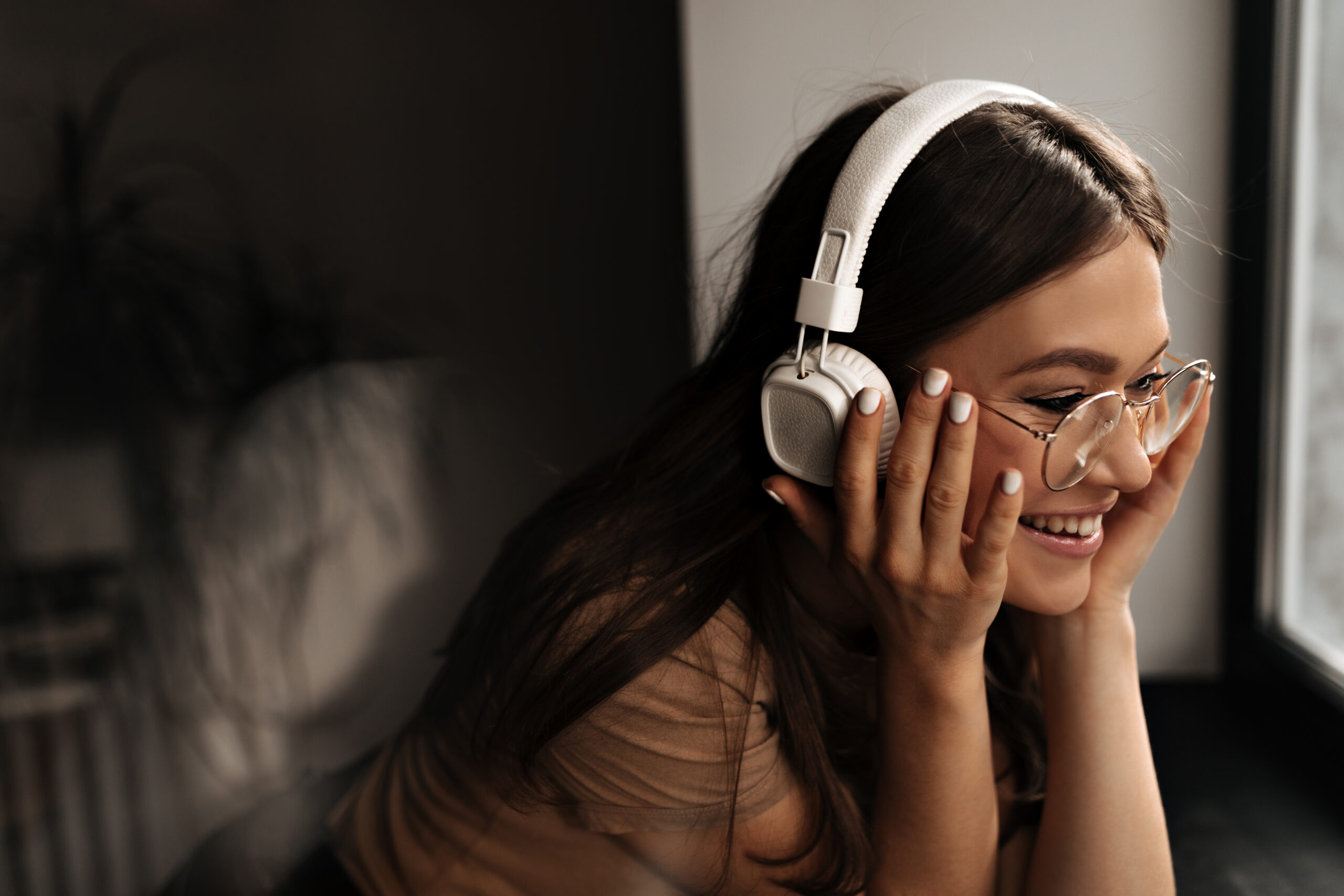 A woman with headphones on listening to music.